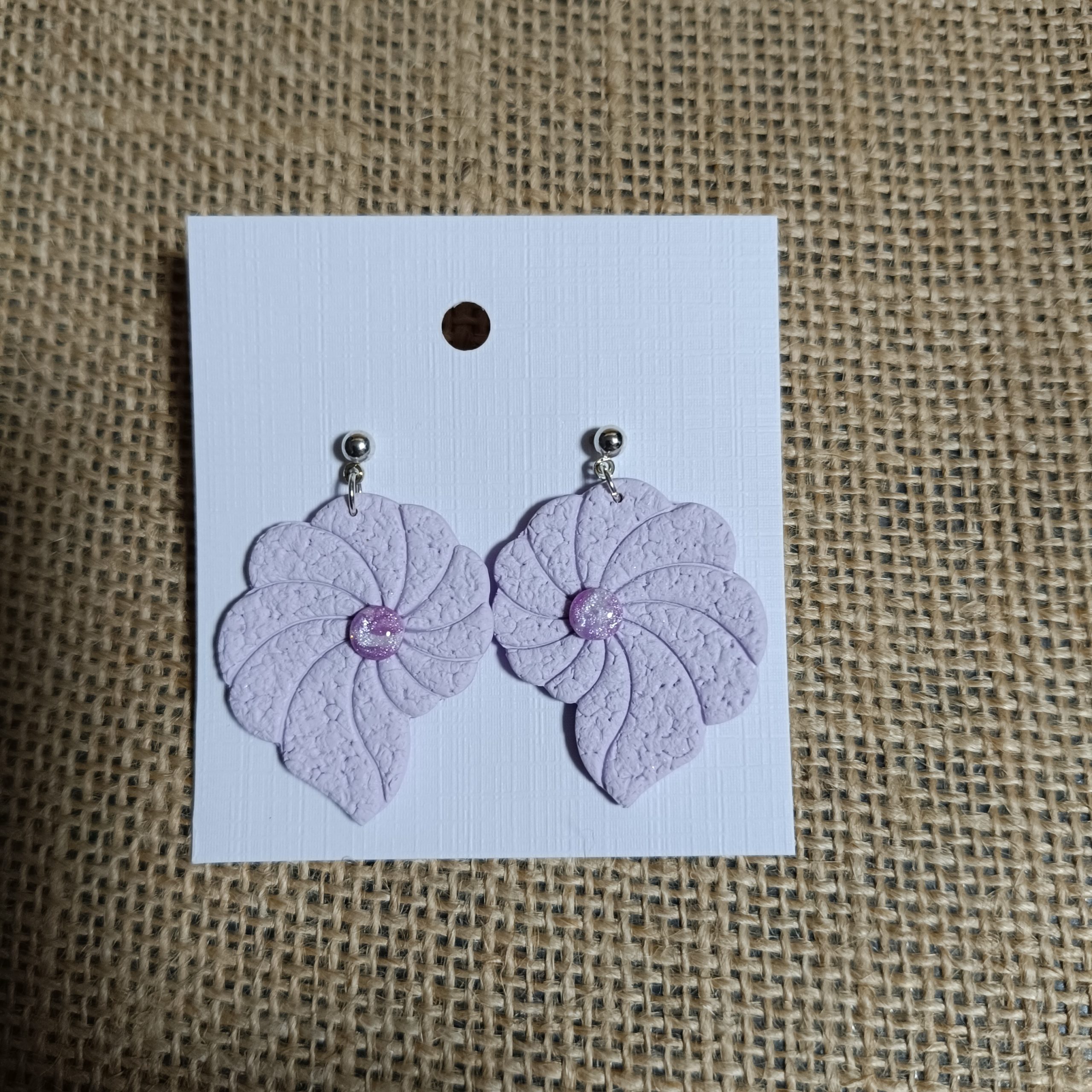 Lavender polymer clay flower earrings with silver-tone hooks.