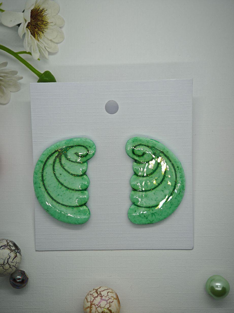 Handmade green polymer clay earrings with a glossy finish.