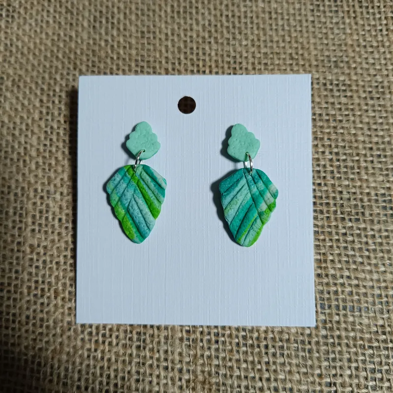 Handmade leaf-shaped earrings in green and blue tones.